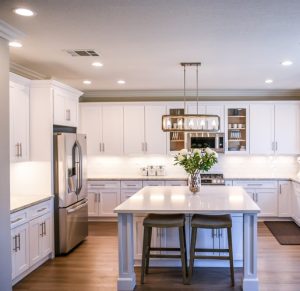 Kitchen with white cabinets and large white island in the middle