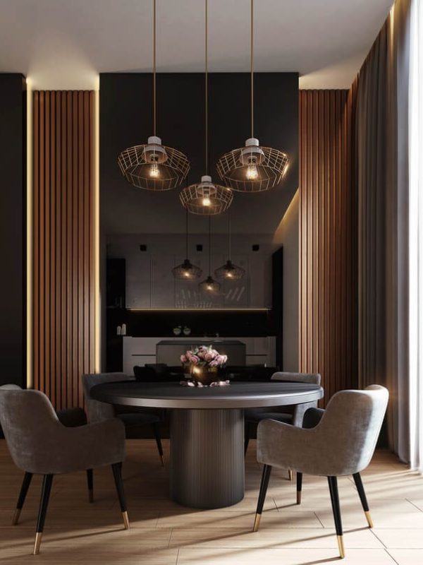 Sleek, round grey dining table with 4 chairs under 3 hanging pendant lights