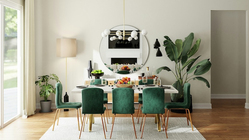 Dining room with a white table and green chairs under neath a modern chandelier