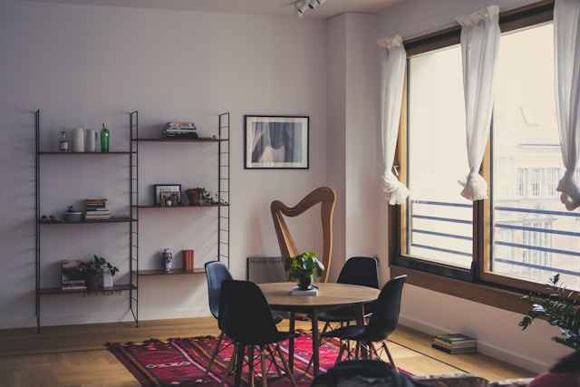 Dining room with windows, dining table, and wall-mounted shelves